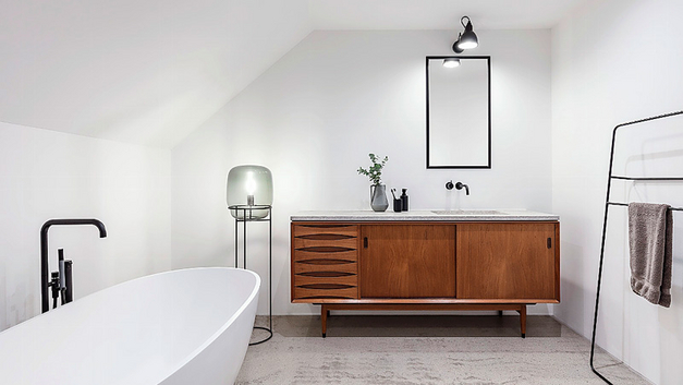 Alt trifft auf neu: umfunktioniertes Vintage-Sideboard und freistehende Wanne in Hadlikon. BILDER MERK RAUMGESTALTUNG / LEA HEPP / KILIAN KESSLER